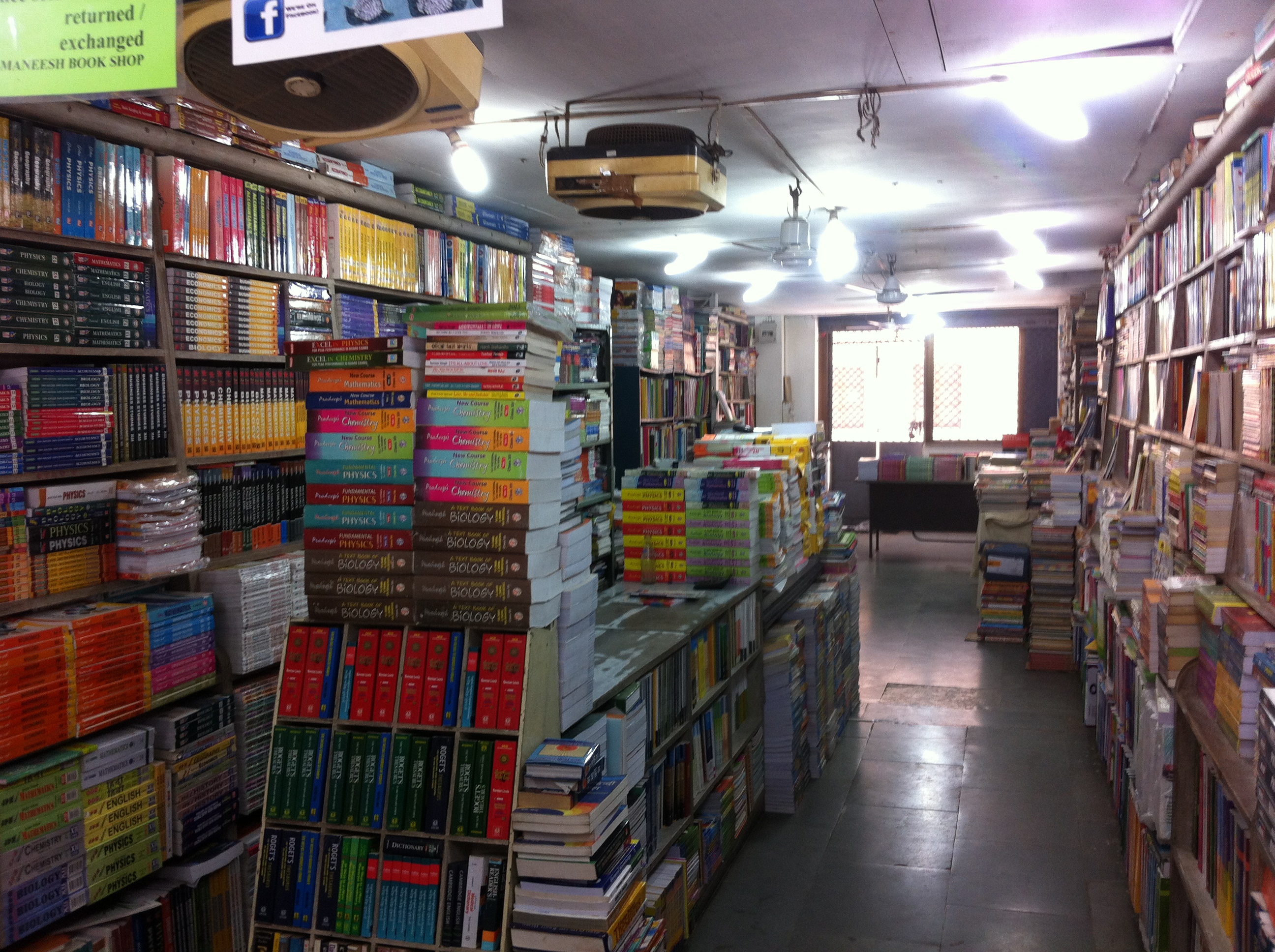 A nostalgic view of Maneesh Book Shop with shelves and stacks of books
